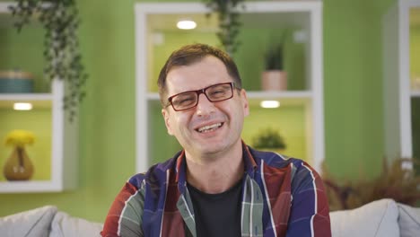 Happy-glasses-man-laughing-and-saying-something-to-the-camera.